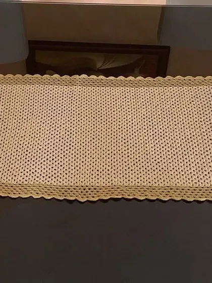 The simple stitch and clean border of this gold runner make it a perfect backdrop for any centerpiece.