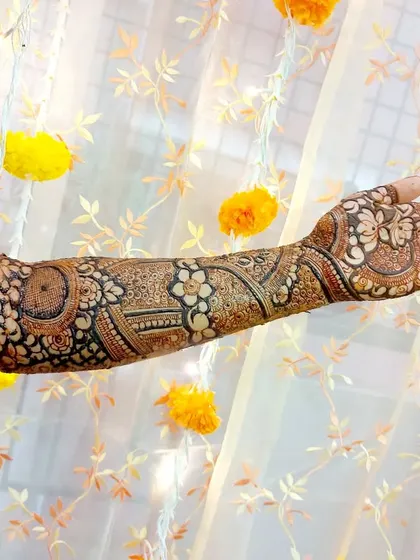 A single-arm view of a floral-themed bridal design, with a beautiful lighted curtain in the background.
