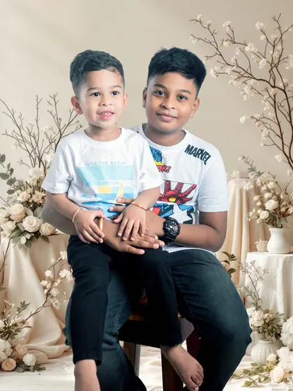 The bond between brothers captured in a sweet studio portrait. We create a fun environment to bring out the natural interaction between siblings.