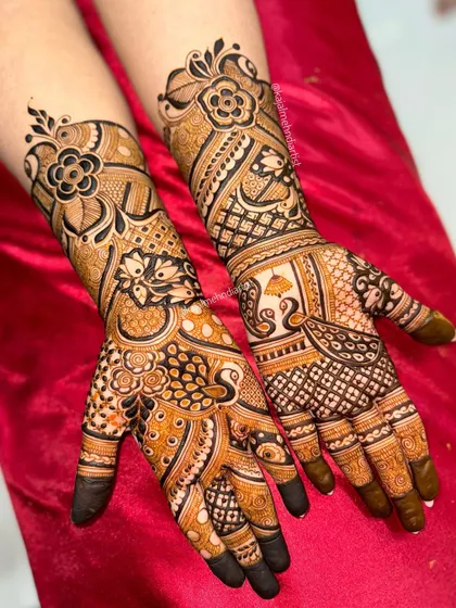 A complete view of a stunning engagement henna set. Both hands are adorned with a mix of bold flowers, peacocks, and traditional Indian motifs, perfect for celebrating a new chapter.