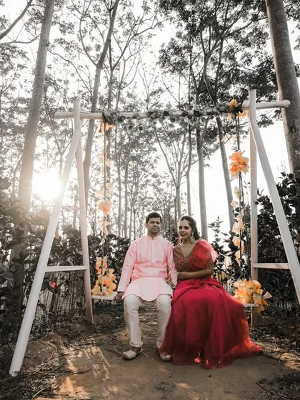 This serene pre-wedding portrait was taken in a beautiful wooded area. The swing and the soft sunlight create a dreamy, fairytale-like atmosphere for the couple's photo.