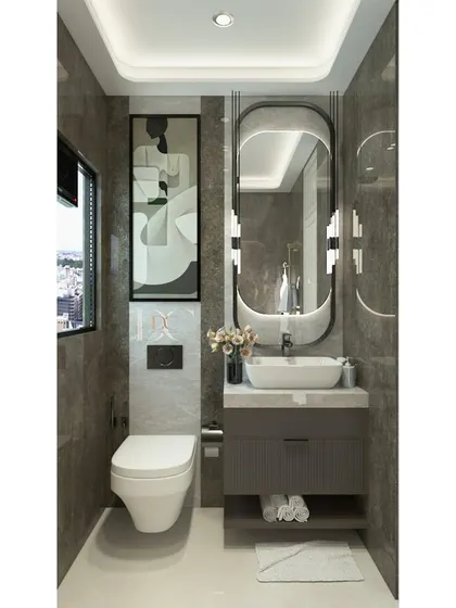 A sleek and modern powder room design. The dark grey tiles, wall-mounted toilet, and compact vanity unit with open storage create a space that is stylish, functional, and easy to clean.
