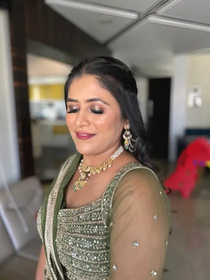 A soft and warm makeup look for this client in an olive green lehenga. The gold-toned eyeshadow and nude lip are a classic combination.