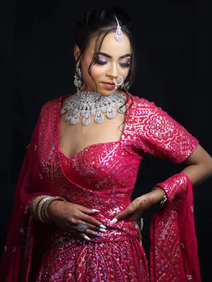 A modern bridal look featuring a shimmering pink lehenga and diamond jewelry. We teach students to create contemporary and glamorous styles.