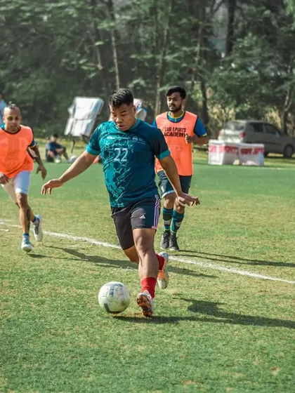 A player dribbles through the opposition during a training game.
