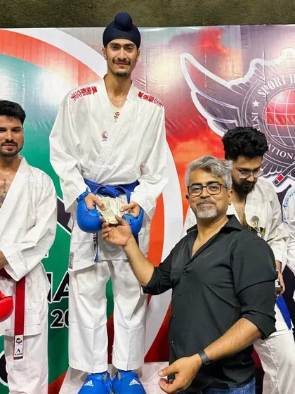 Receiving the prize money for my win at the India Open. Professional karate offers rewards for those who reach the top.