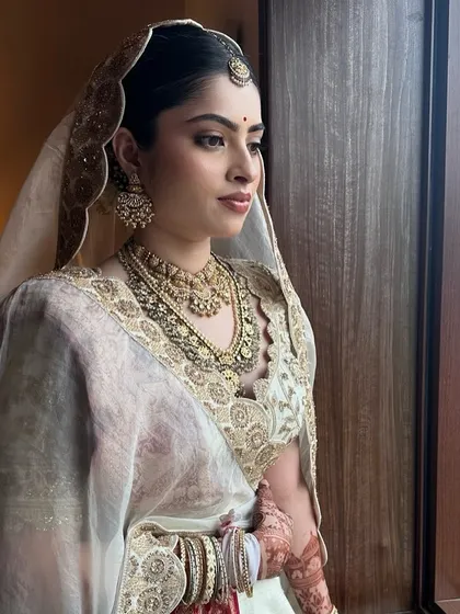 Looking out at her future. This quiet moment captures the soft elegance of Sanya's bridal style.