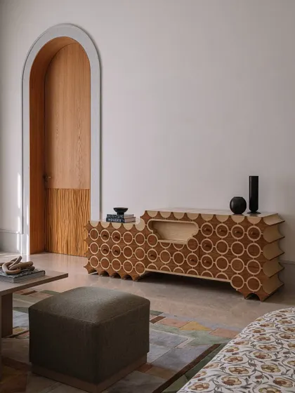 The 'Brutus' TV unit, another handcrafted piece from our collection, features a unique pattern of inlaid circles and a scalloped base.