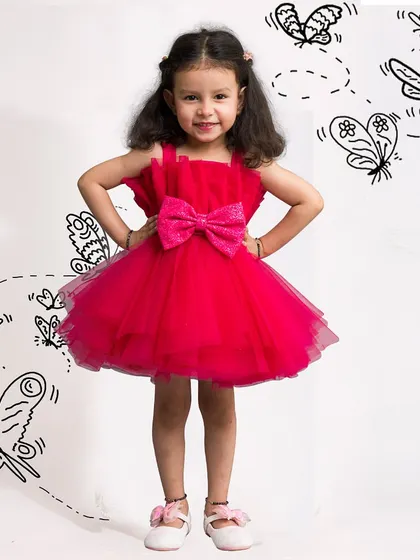 This bright red short dress with a sequin bow is made for happy moments and playful fun.
