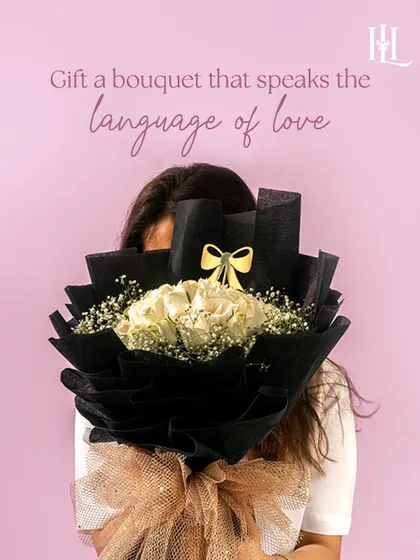 Gift a bouquet that speaks the language of love. This elegant arrangement of white roses wrapped in black paper is a symbol of pure love and a timeless Valentine's gesture.