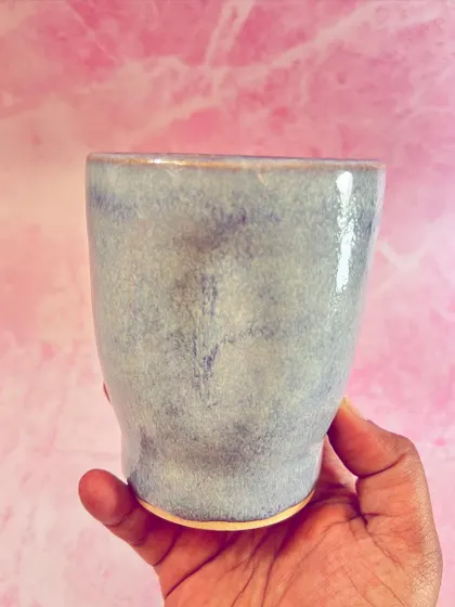 Holding this mug, you can appreciate its smooth finish and comfortable shape.