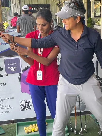 Demonstrating the follow-through position. By physically guiding the student, I can help them understand the full motion of a balanced and complete golf swing.