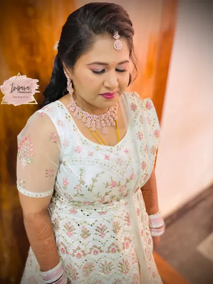 A close-up of the bride's reception makeup. This HD look features a cut-crease eye and a soft pink lip, designed to enhance her features for the evening celebration.
