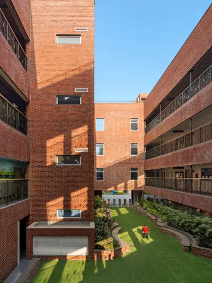 At HRM Global School in Delhi, we designed outdoor spaces to be layered and responsive. This central green court, viewed from above, shows the balance between open play areas and shaded alcoves, creating a campus that encourages exploration and spontaneity.