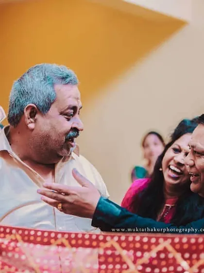 Laughter and fun with family are at the heart of every Indian wedding. This candid shot captures a playful interaction during a wedding ritual.