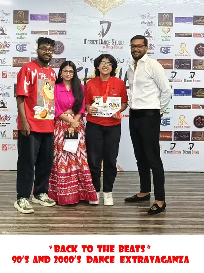 A winner receiving her award at the "Back to the Beats" dance event.