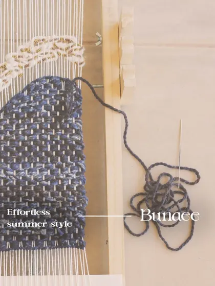 This is not fast fashion. This image shows the "Bunaee" or weaving process, highlighting the sustainable and impactful quality that comes from expert, handcrafted tailoring.