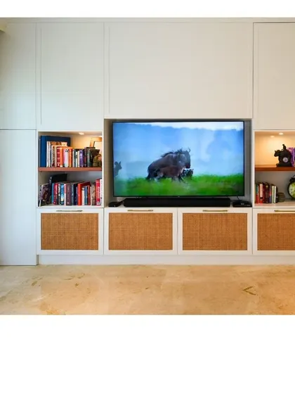 This TV unit is a perfect example of American Ranch style design, with its built-in library shelving and warm, natural textures creating a cozy and functional entertainment center.