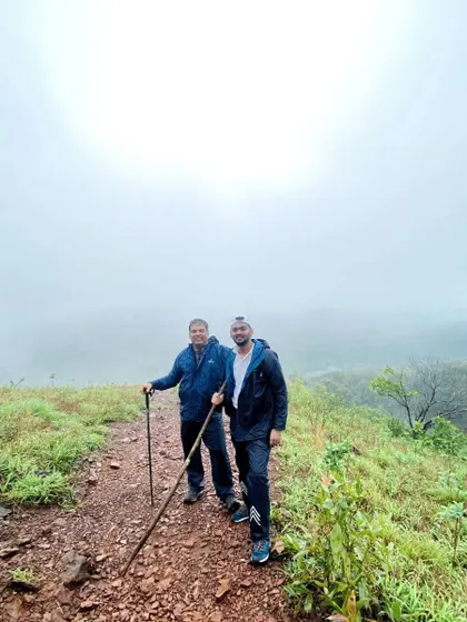 Two adventurers on the Kodachadri trail, surrounded by thick fog. This shows the challenging yet atmospheric conditions we navigate.