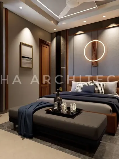 We designed this modern bedroom with a focus on mood and ambiance. A circular LED light fixture on the textured headboard wall creates a unique artistic statement. The combination of dark wood, grey fabric panels, and deep blue textiles results in a sophisticated and masculine aesthetic.