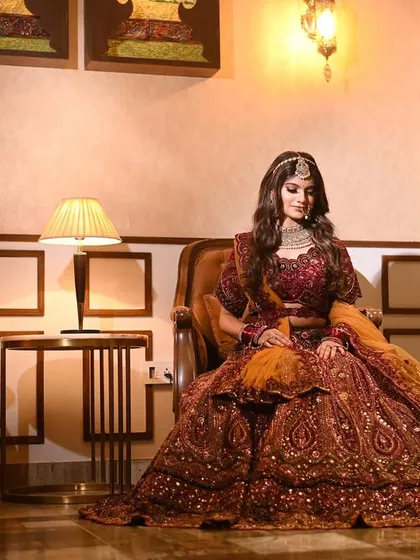 A regal bridal portrait. The elegant setting and lighting complement the bride's majestic presence in her traditional attire.