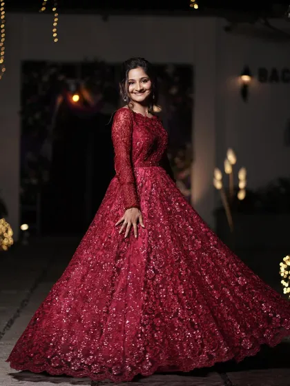 Monica twirling in her gorgeous red reception gown. The makeup was designed to be long-lasting and photo-ready for a night of celebration.