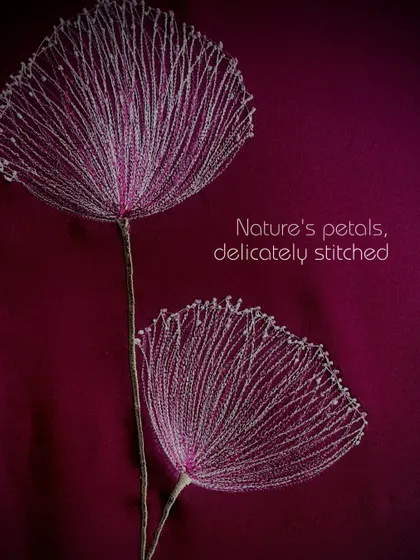 Nature's petals, delicately stitched. This abstract dandelion-like flower is created with fine threads to give a sense of lightness and airiness.
