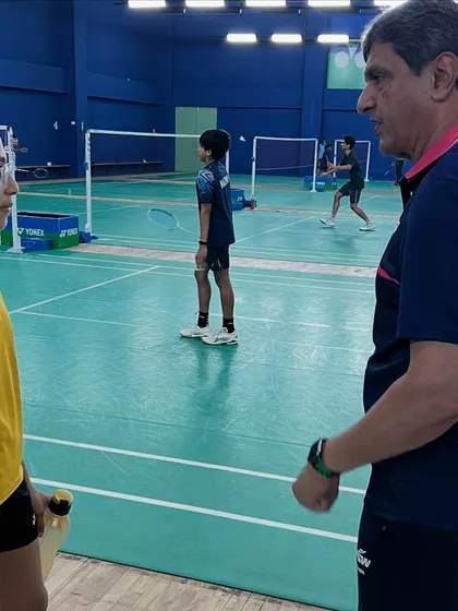 One-on-one advice from a legend. Prakash sir takes a moment to speak with a young player, offering personalized feedback to help her improve her game.