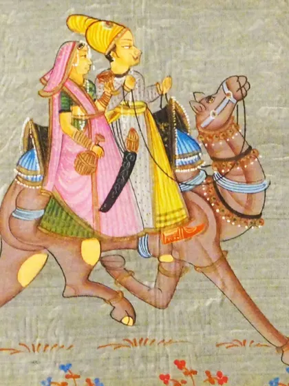 A delicate Miniature painting of a royal couple on a camel. Our specialized workshops teach the fine brushwork and detailed precision required for this exquisite art form.