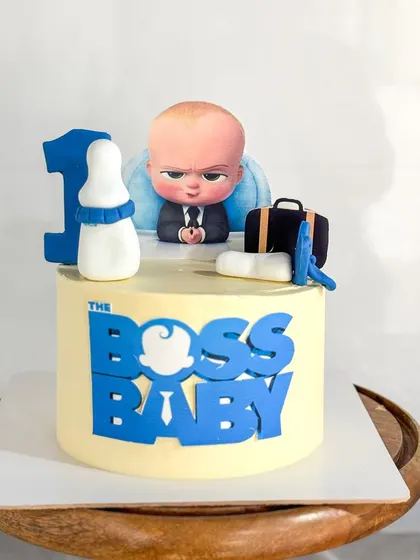 Who's the boss? This Boss Baby themed cake was for a very special 1st birthday. It features the iconic logo and handmade fondant accessories like a briefcase and milk bottle.
