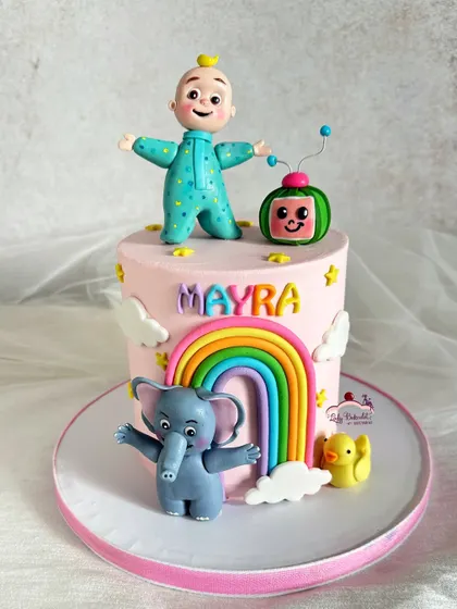 A sweet and simple Cocomelon cake with JJ, the watermelon TV, a friendly elephant, and a bright rainbow. The handcrafted sugar figures add a personal touch.