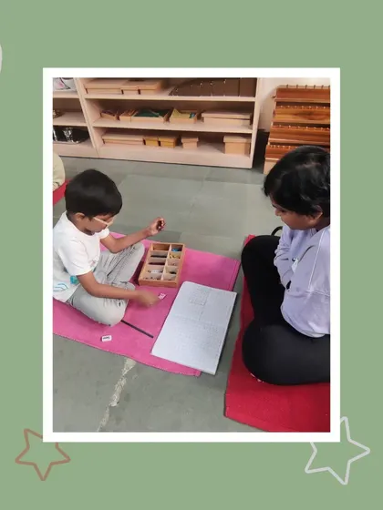 Aarav works on multiplication using the stamp game, a material that makes abstract math concepts concrete and understandable. His mother is amazed to see him tackling such advanced work.