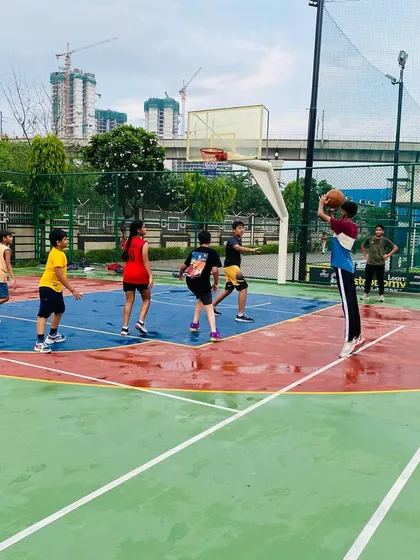 A jump shot goes up as the rain comes down.