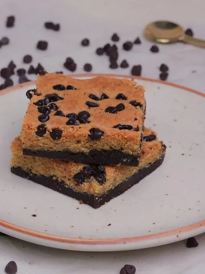 Another view of our popular Cookie Dough Brownie, surrounded by chocolate chips to emphasize the key ingredient.