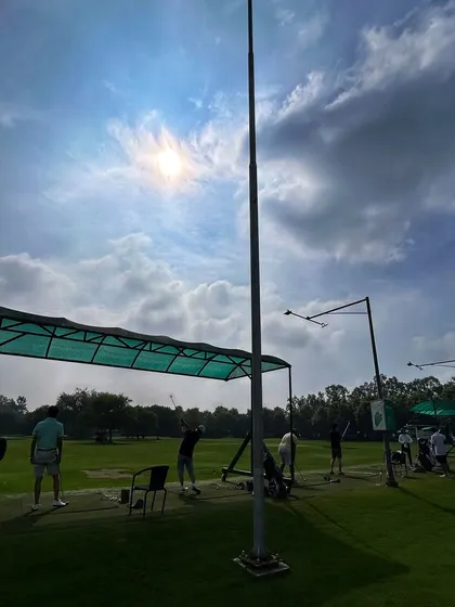 The sun beats down as golfers practice their swings from the shade of our covered bays.