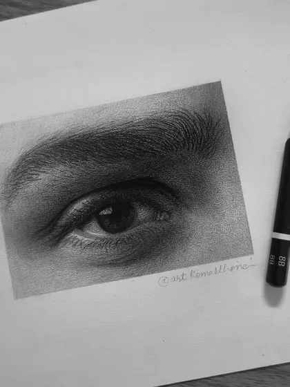 A detailed study of an eye, created using both graphite and charcoal to achieve deep blacks and soft skin tones.