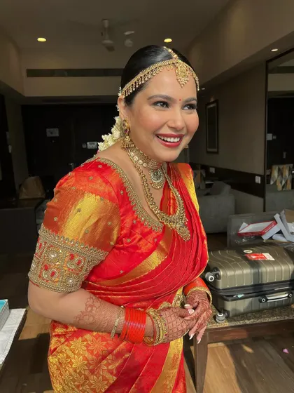 A candid moment of laughter. The makeup looks natural and radiant, even in a spontaneous shot.