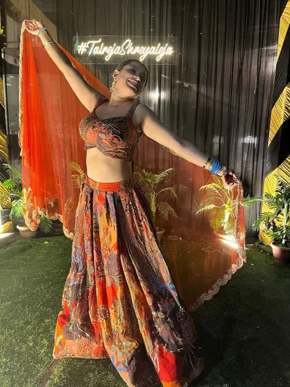 A fun, twirling shot in the vibrant Aisha Rao lehenga. It's a perfect outfit for a sangeet night, full of color and life.