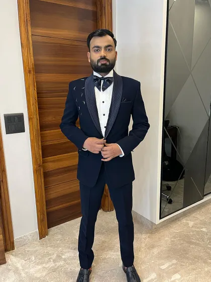 Another angle of this sharp tuxedo look. The fit of the suit and the clean grooming work together to create a powerful and confident presence.