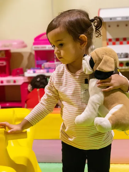 Taking her plush puppy for a tour of the playhouse. Our space is perfect for kids to bring their favorite imaginary friends along for the ride.