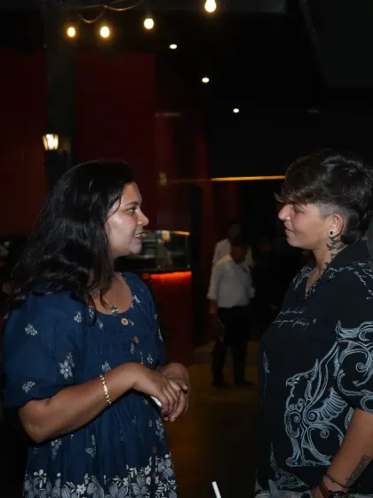 Connecting with guests is a key part of what I do. Here, I'm chatting with one of the mothers at an all-women gathering, ensuring everyone feels welcomed and included.