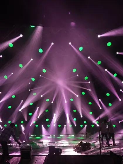 Dancers rehearsing on the 'Po Po' set under one of the lighting looks, a combination of purple beams and green washes.