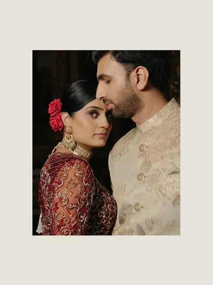 A soulful, artistic portrait of Uha and Ravi from their wedding at the Taj Falaknuma in Hyderabad, her red rose adding a touch of classic romance.