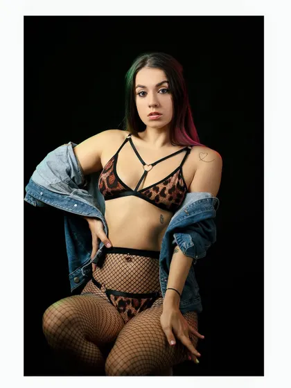 A more revealing shot from the same series, showcasing the model's edgy style with an animal print lingerie set.
