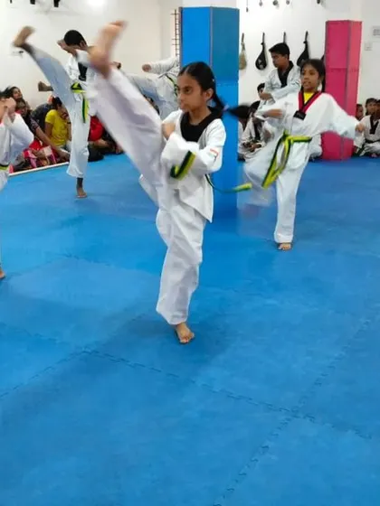A dynamic shot of students practicing high kicks.