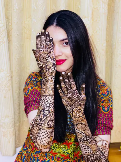 A classic peek-a-boo pose from the bride, her bright lipstick matching the joy in her eyes.