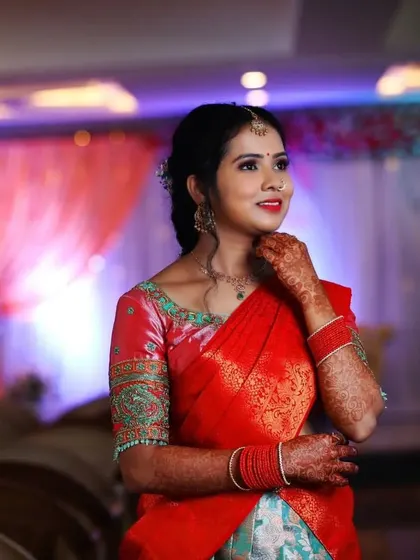 A candid moment from Priya's engagement ceremony. Her makeup was designed to look fresh and bright, with a focus on her smile, ensuring she looked effortlessly beautiful.