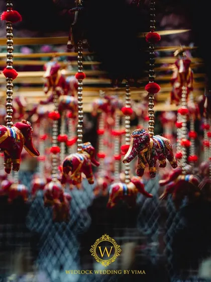 For this Varapuja ceremony, we used a vibrant palette of reds and pinks. The decor included hanging elephant charms and a mirrored backdrop to create a festive and prosperous atmosphere.