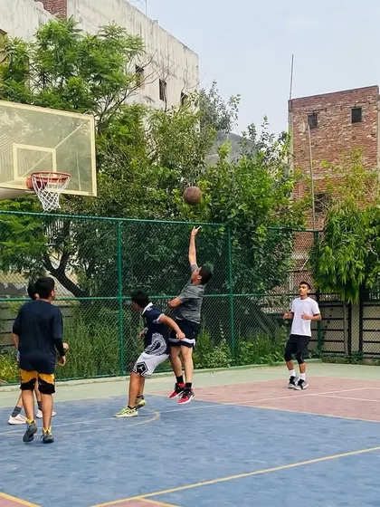 A tough defensive play as a player contests a shot, forcing a difficult attempt.