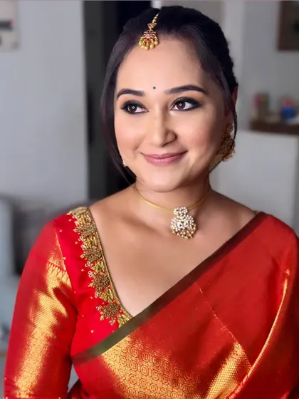 Chaitra looking stunning for a family event. I created a classic look with winged eyeliner and a simple jasmine bun to complement her red Kanjeevaram saree.